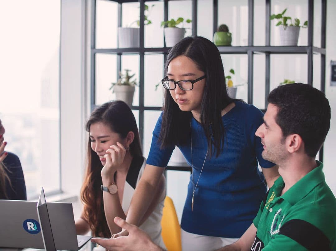 Product and web team collaborating around a workstation